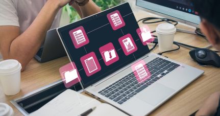 Ein Foto auf dem Ein aufgeklappter Laptop zu sehen ist, auf dem Ordner geöffnet sind.